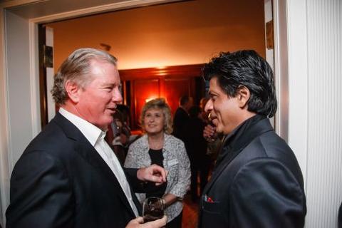 Shah Rukh Khan speaks to a guest at Timothy Dwight College Fellows reception